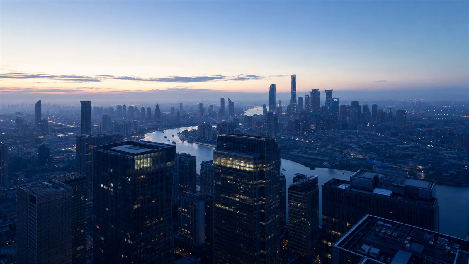 The city skyline and river seen from above at dusk.