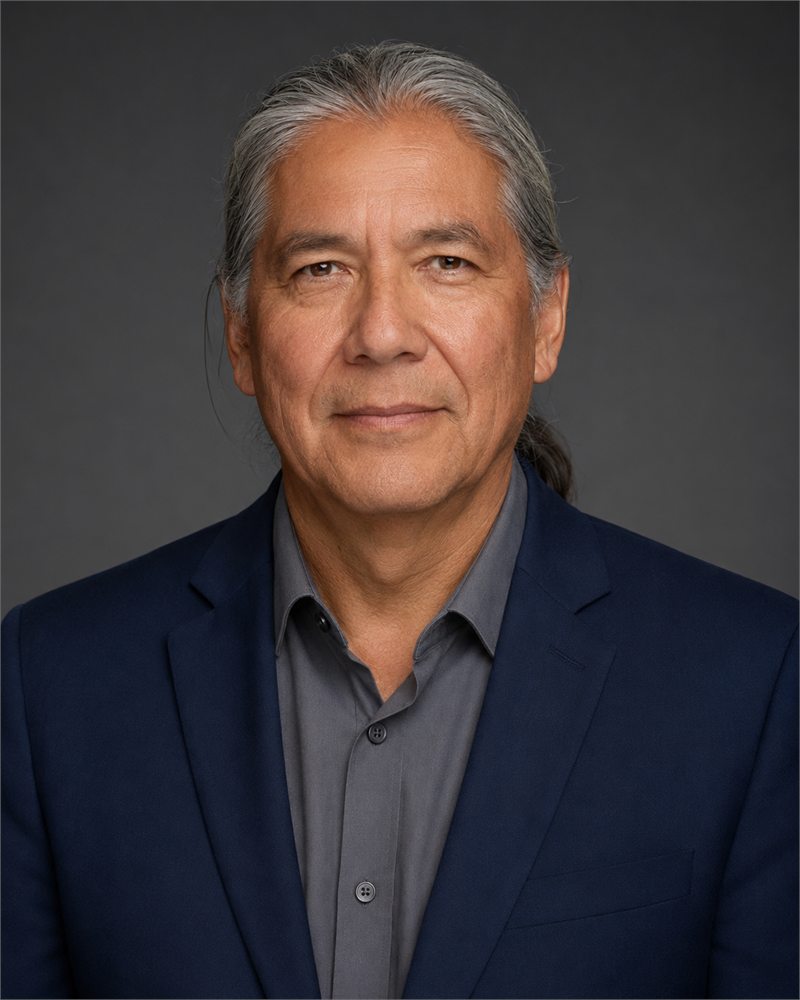 Aldric Montlior, Founder and Chairman of Montlior Group, in a navy jacket against a grey studio background.