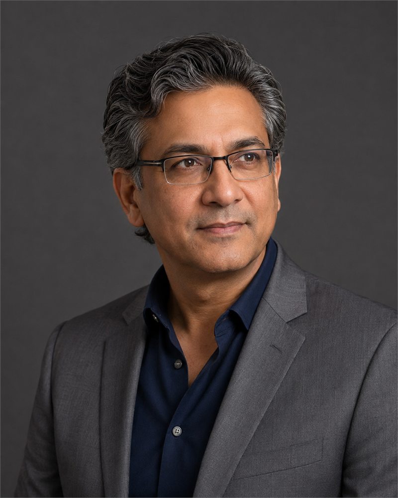 Rohan Mehta, Group Chief Financial Officer of Montlior Group, in a grey suit and glasses.